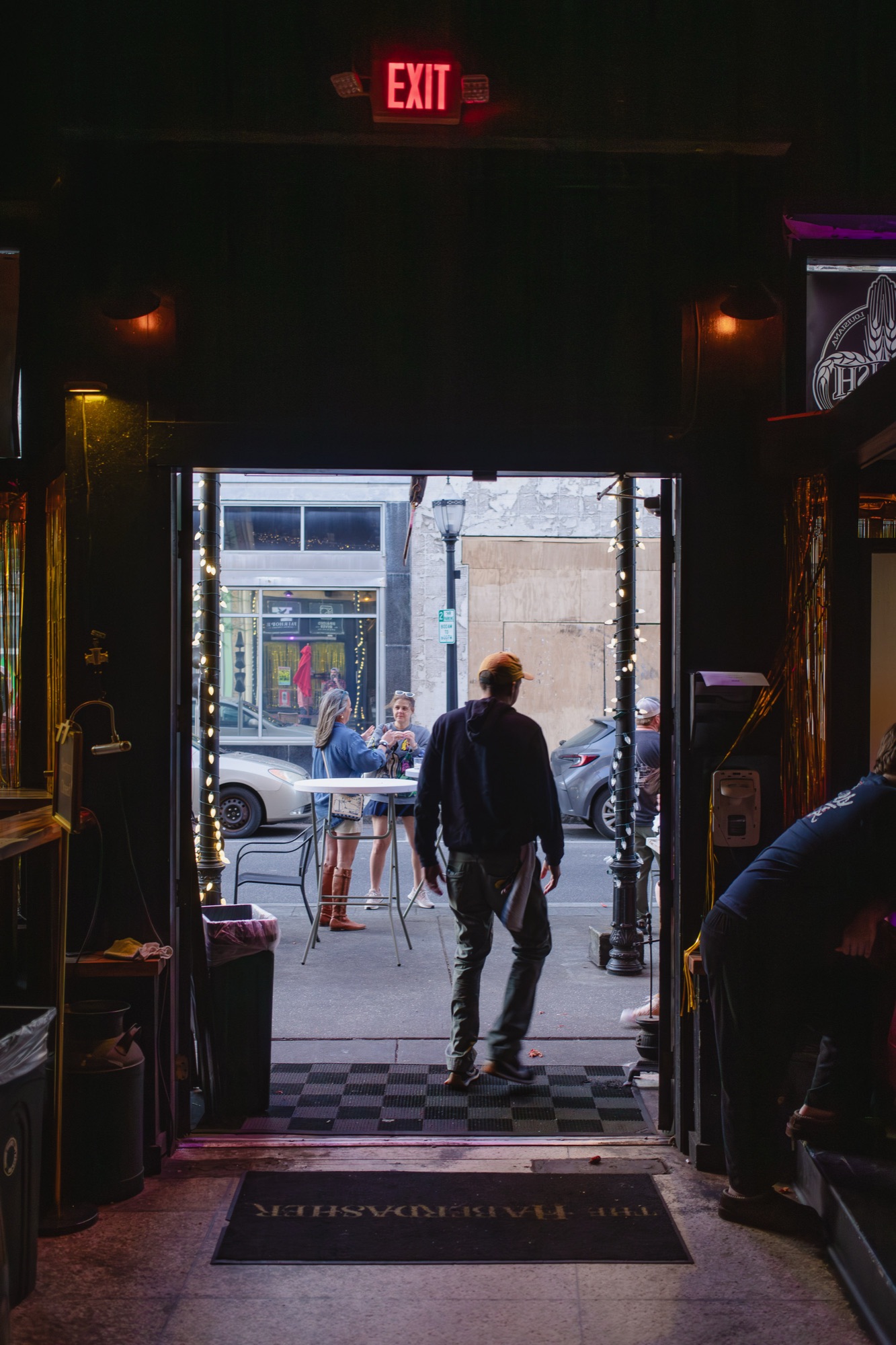 Looking out the doorway of a dark bar onto Dauphin Street